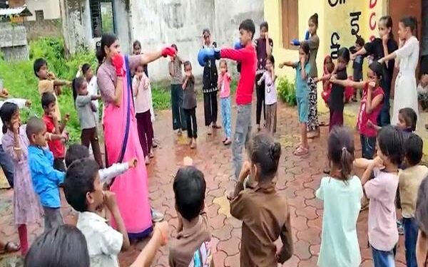 Young children practicing yoga and basic fitness exercises at an Anganwadi centre in Ujjain, India
