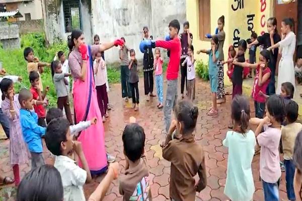 Young children practicing yoga and basic fitness exercises at an Anganwadi centre in Ujjain, India