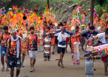 Pilgrims participating in the Kanwar Yatra under stringent security